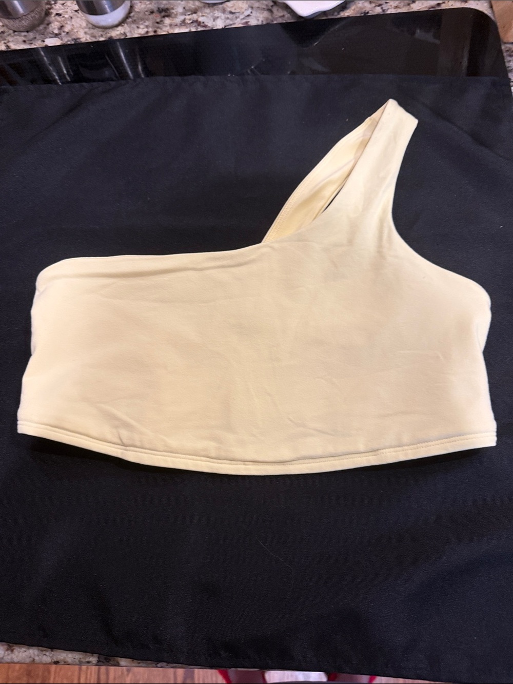ALO Yoga Pale Yellow Crop Sports Bra with silver reflective logo.